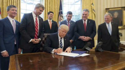 Trump signing one of many new bills.