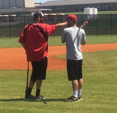 Head Baseball Coach Davis discusses preparation for tournament with Assistant Coach Ferrell.